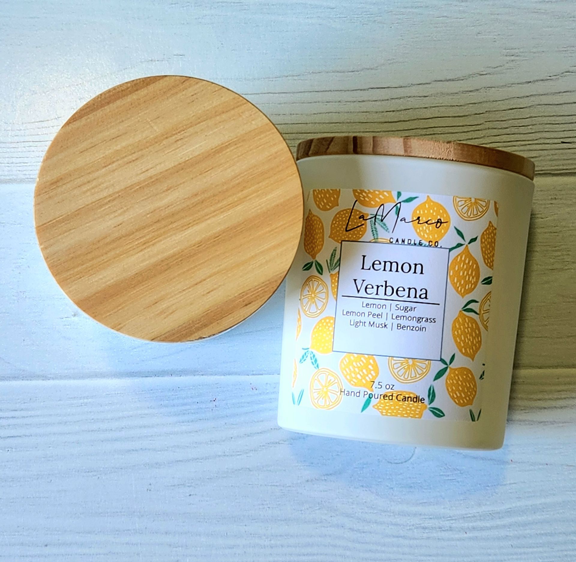 White and orange pumpkin-shaped ceramic containers with gold accents on a reflective orange surface, autumn-themed.