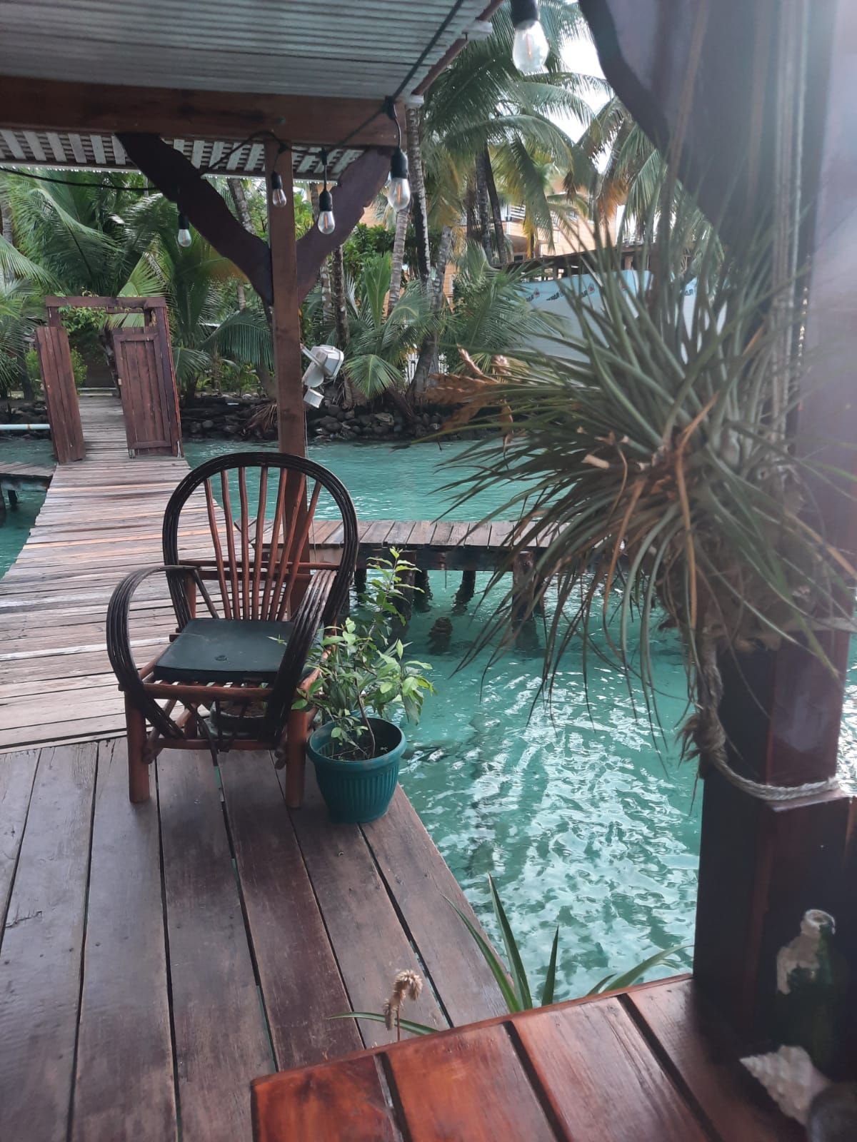 A chair is sitting on a wooden deck next to a pool.