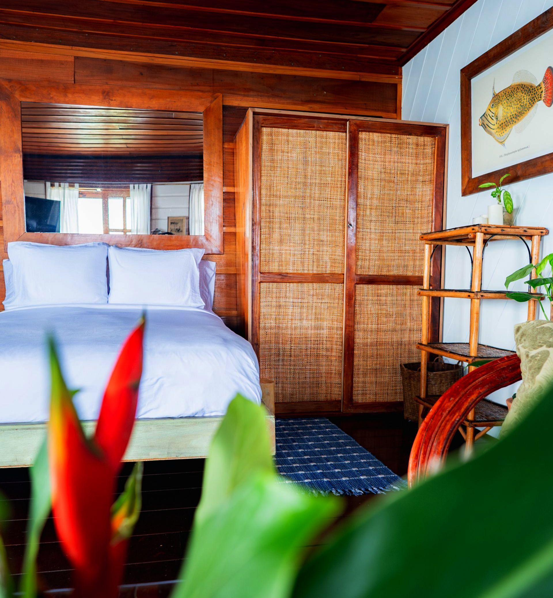 A bedroom with a bed and a picture of a fish on the wall