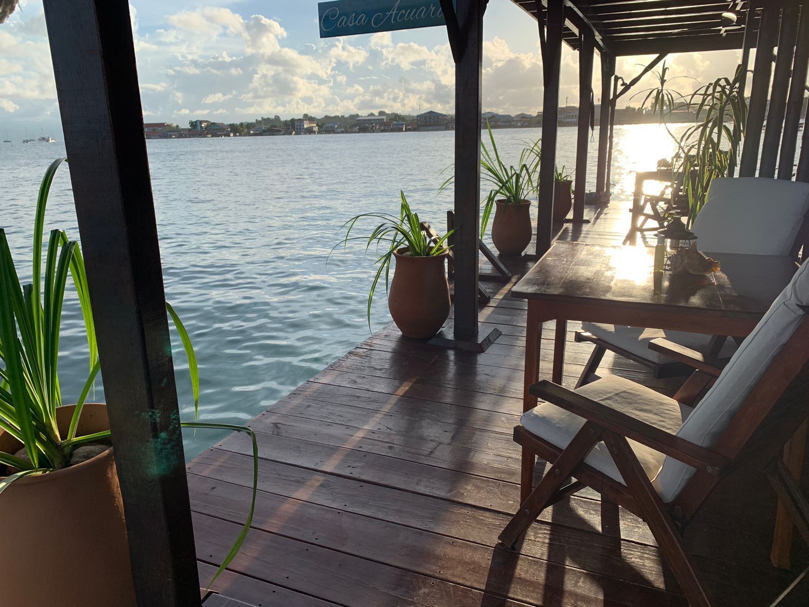 A dock with a table and chairs overlooking a body of water.