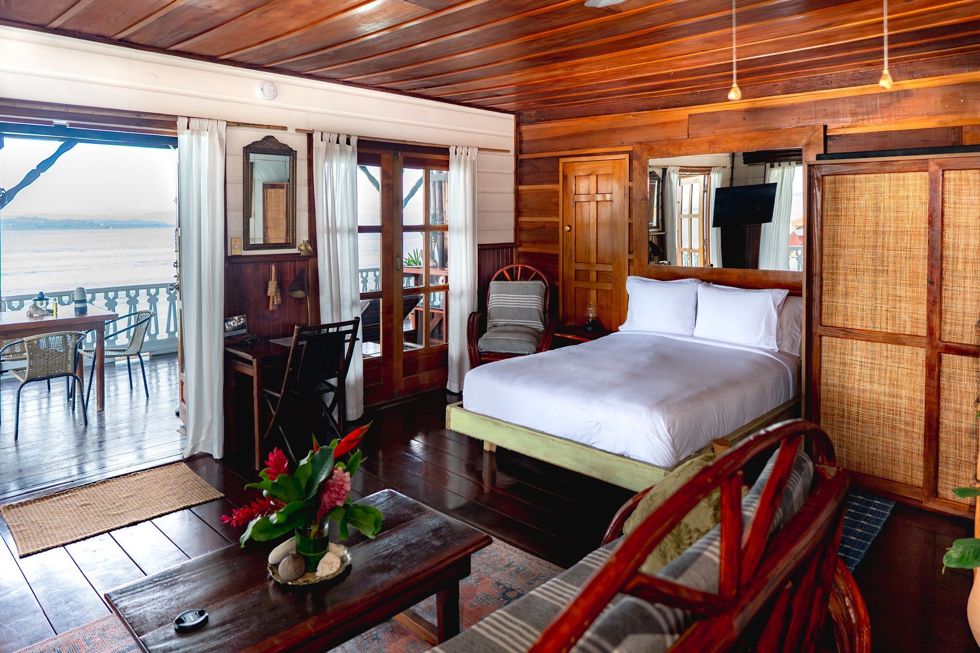 A bedroom with a large bed and a couch