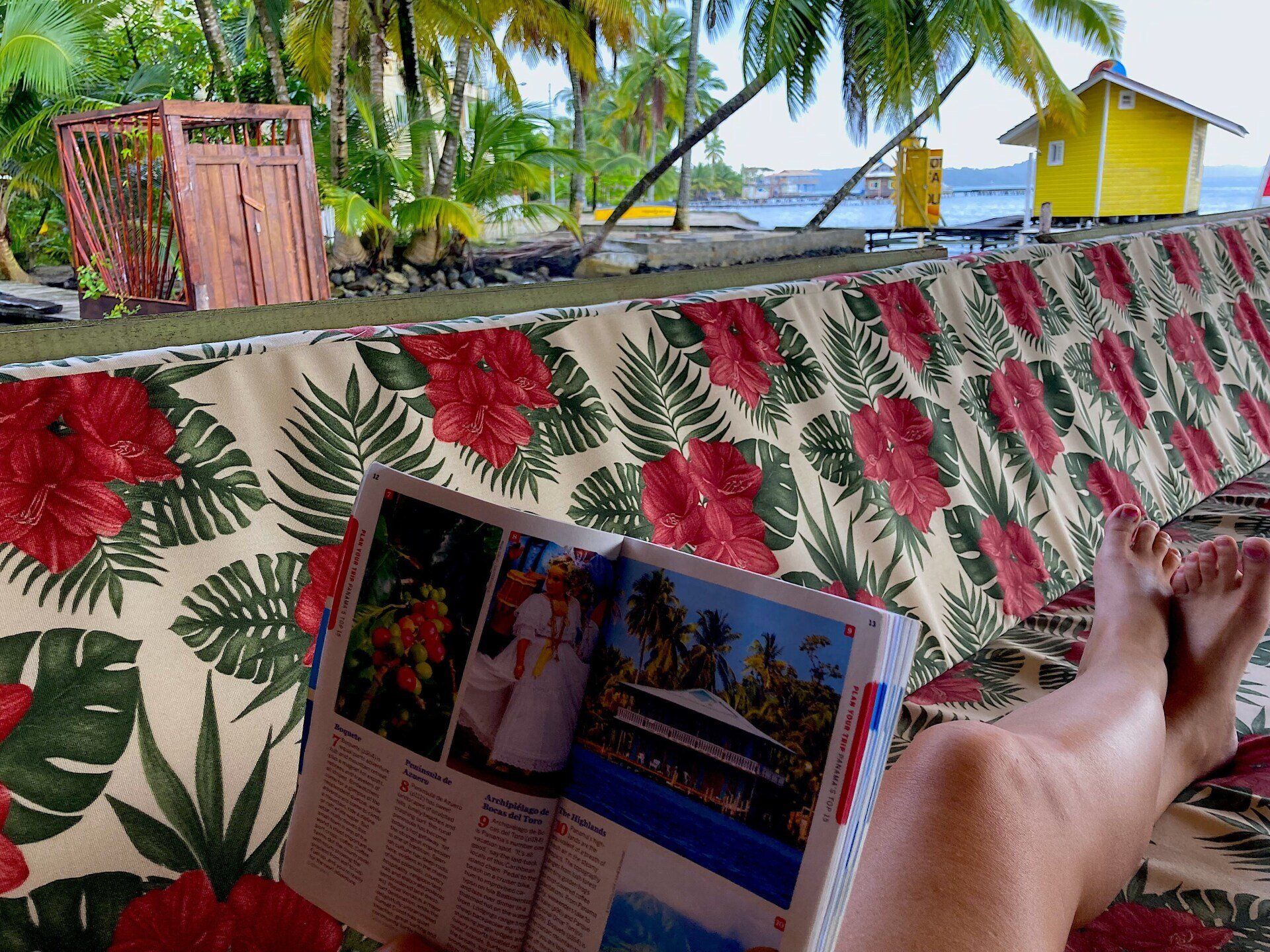 A person is sitting on a couch reading a magazine