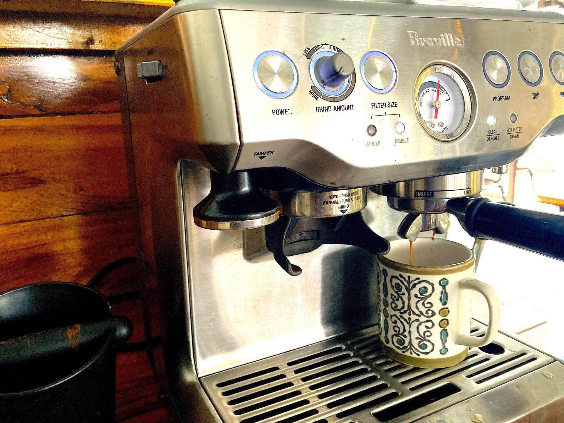 A breville coffee machine is making a cup of coffee