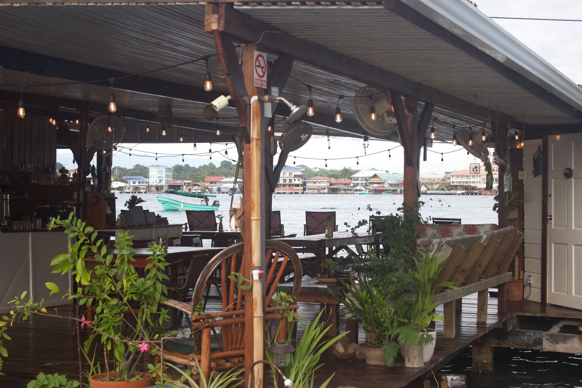 A restaurant with tables and chairs overlooking a body of water