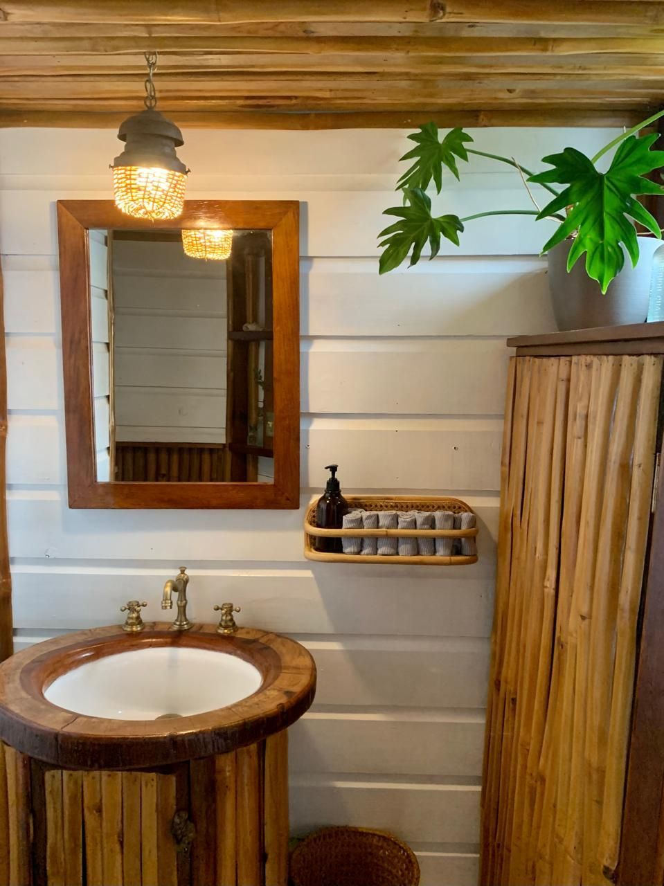 A bathroom with a wooden sink and a mirror