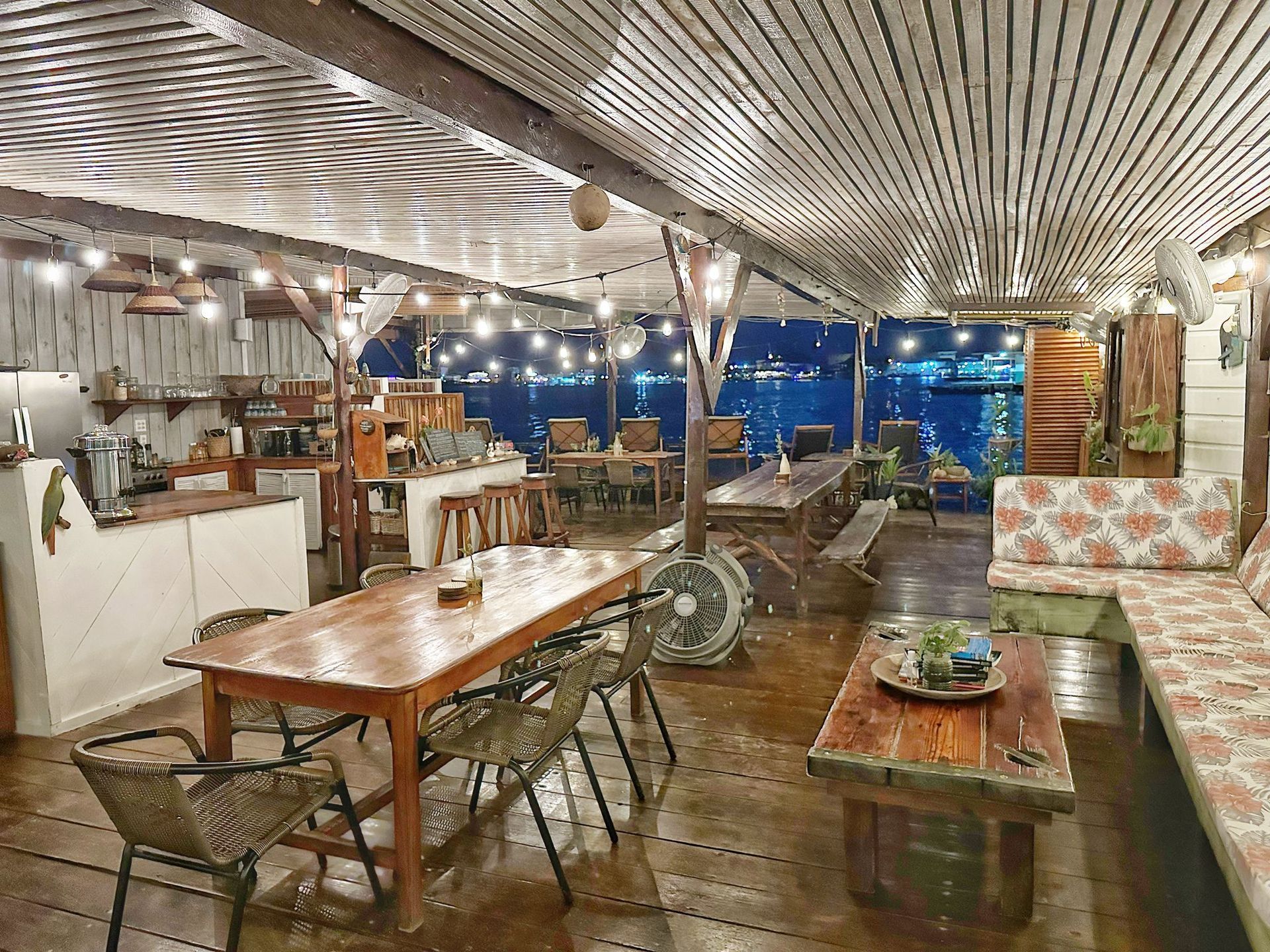 There are many tables and chairs in the room.