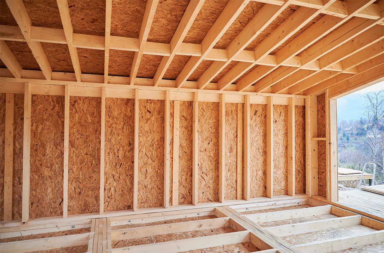 Interior view of wooden construction framing a room.