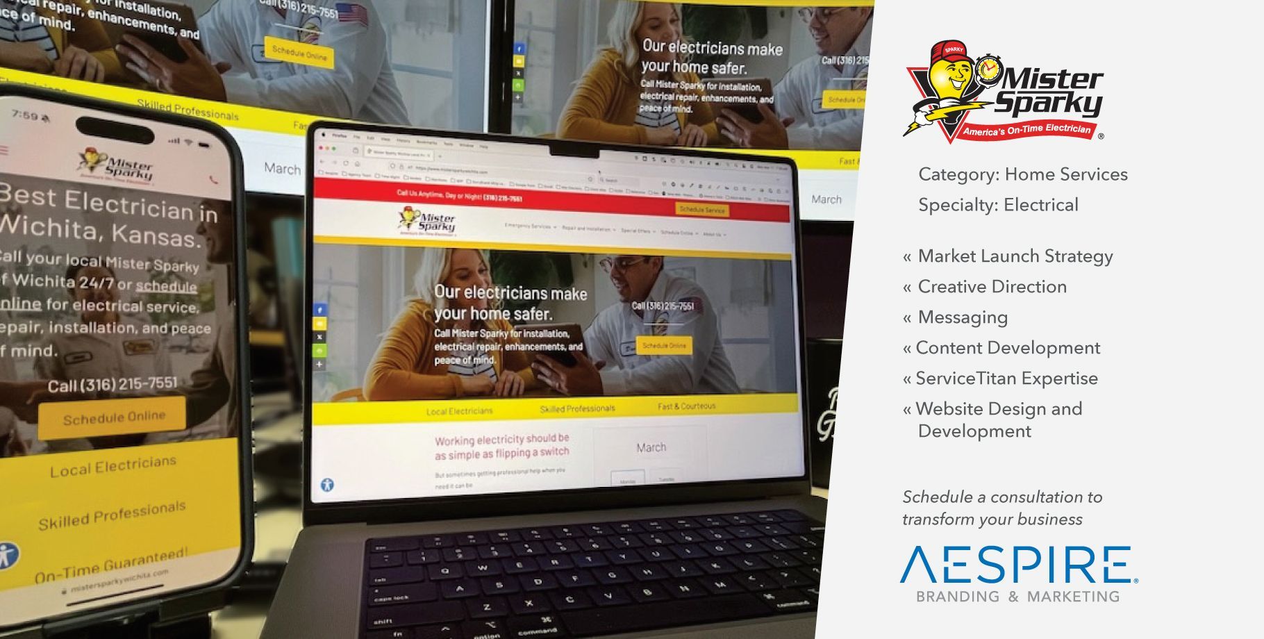 A laptop is sitting next to a phone and a sign that says aspire