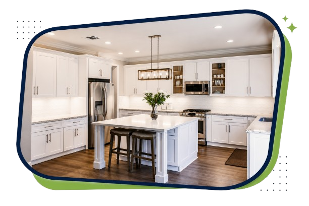 White kitchen with island, stainless steel appliances, and wooden flooring.