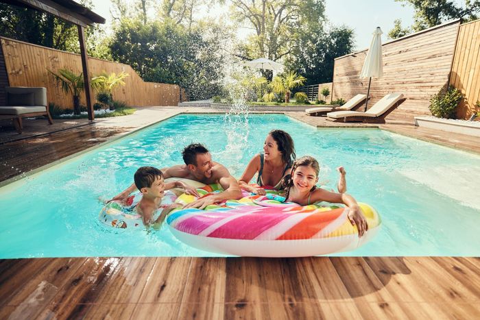 White hot tub filled with clear water; jets visible.