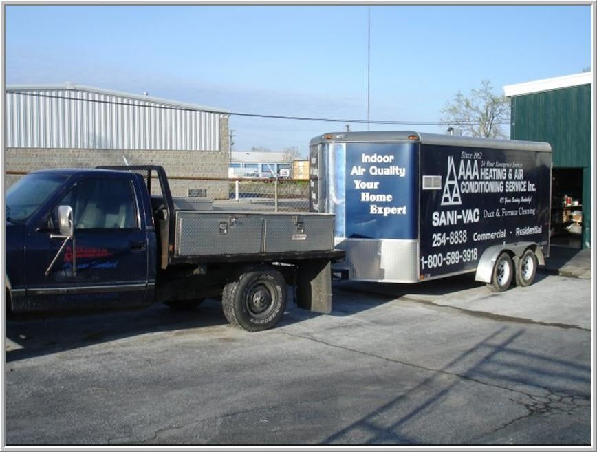 Blue truck towing a trailer with