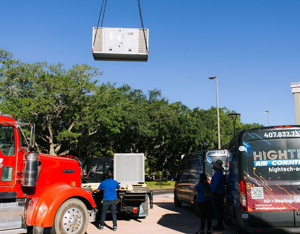 A crane is lifting a piece of equipment into the air