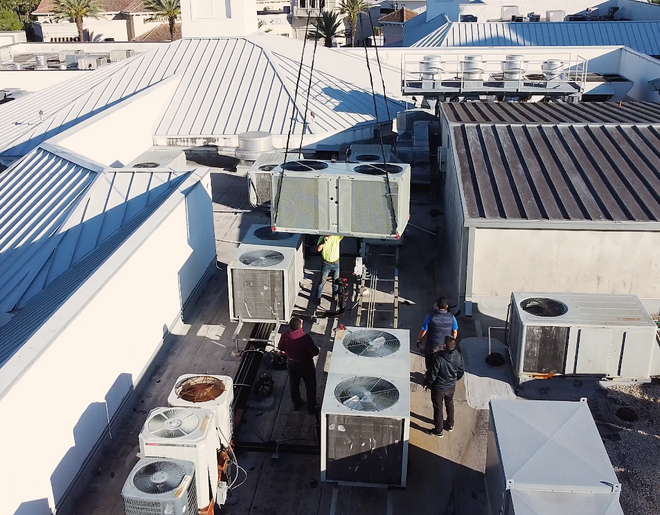 A group of people are working on the roof of a building