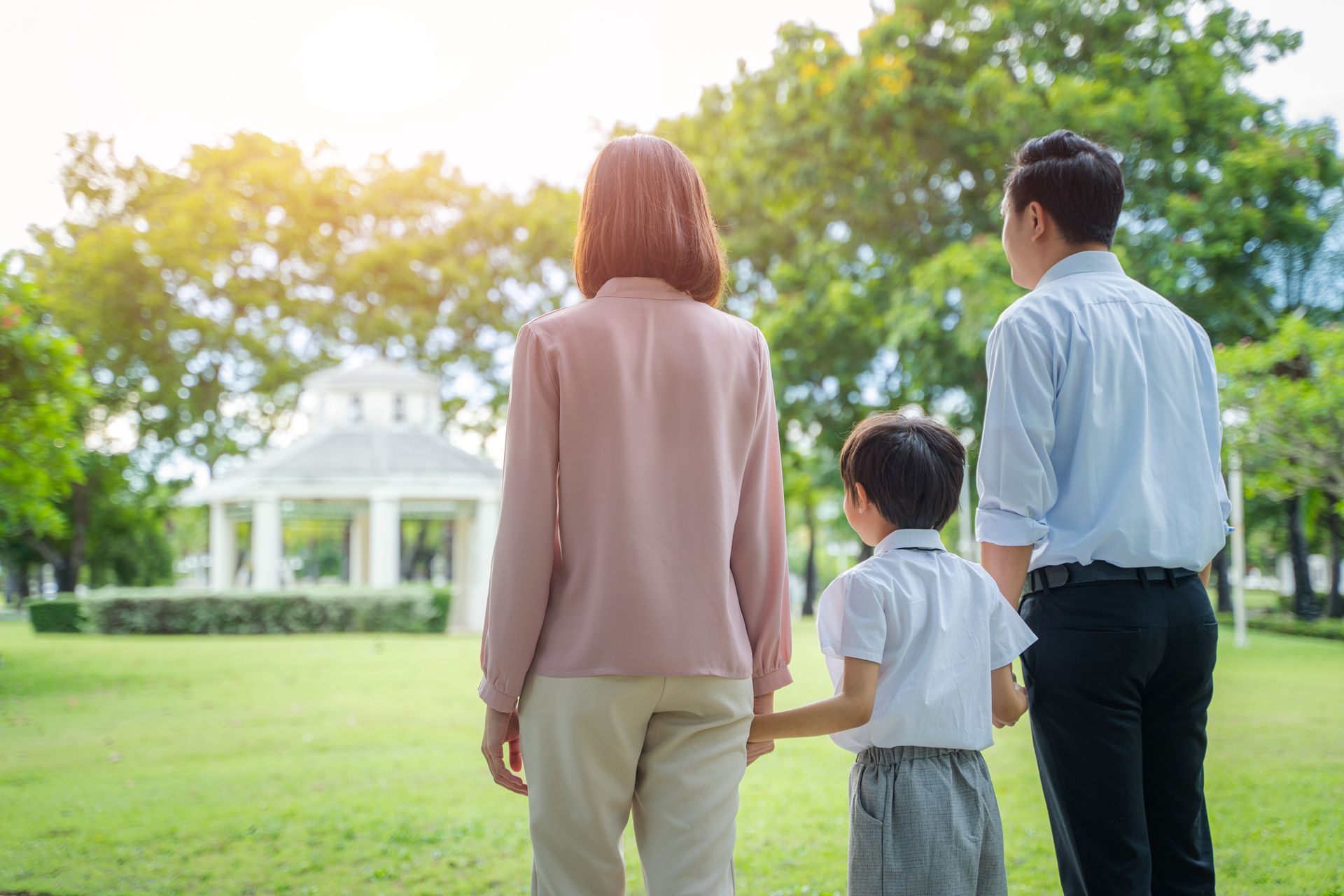 Family walking together in a park — the moments memorials are made to honor