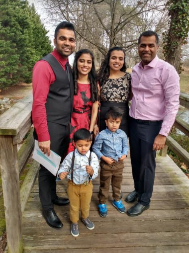 A group of people are posing for a picture on a wooden bridge.