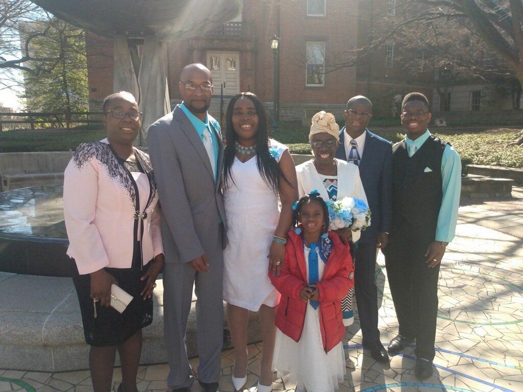 A group of people posing for a picture in front of a fountain