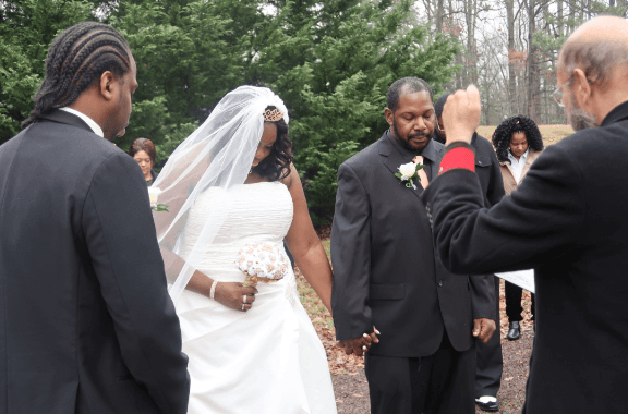A bride and groom are walking down the aisle at their wedding