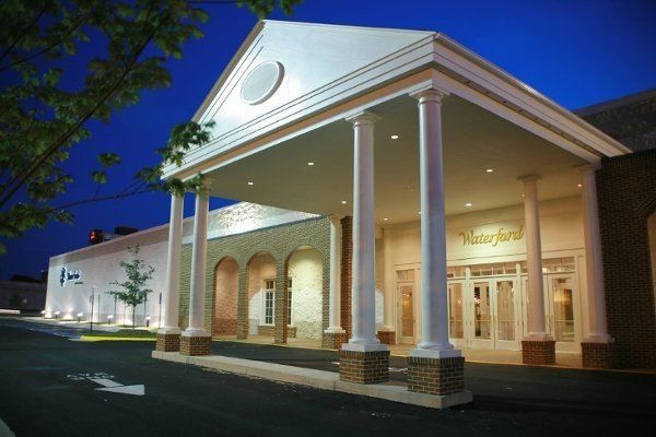 A large white building with columns and a porch at night
