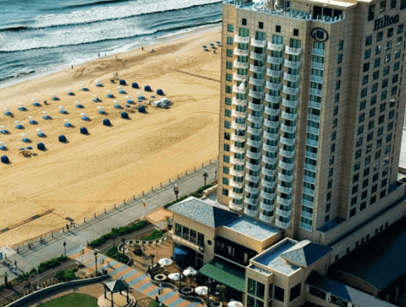 An aerial view of a large hotel next to a beach