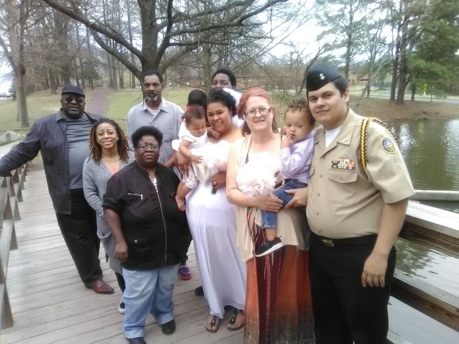 A group of people posing for a picture on a bridge