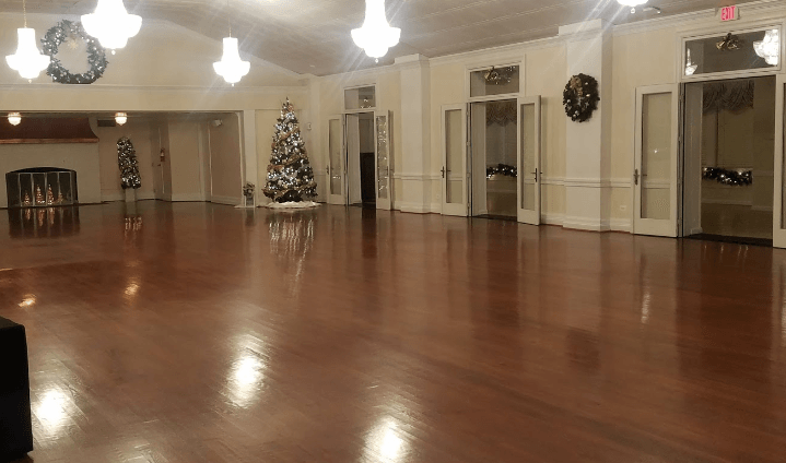 There is a christmas tree in the middle of the room.