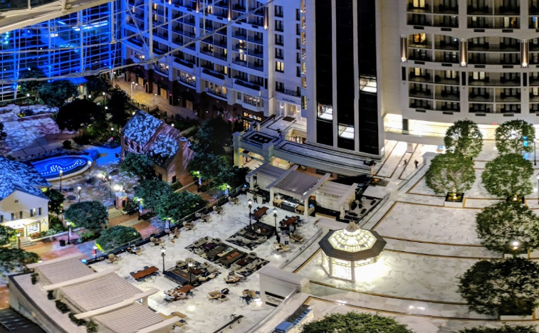 An aerial view of a hotel with a lot of trees and buildings