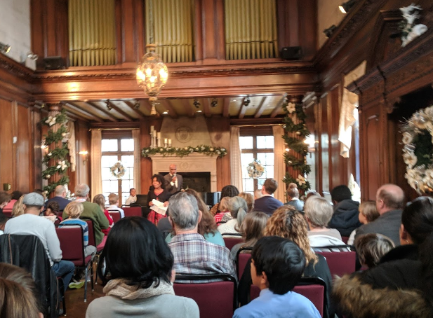 A large group of people are sitting in a large room