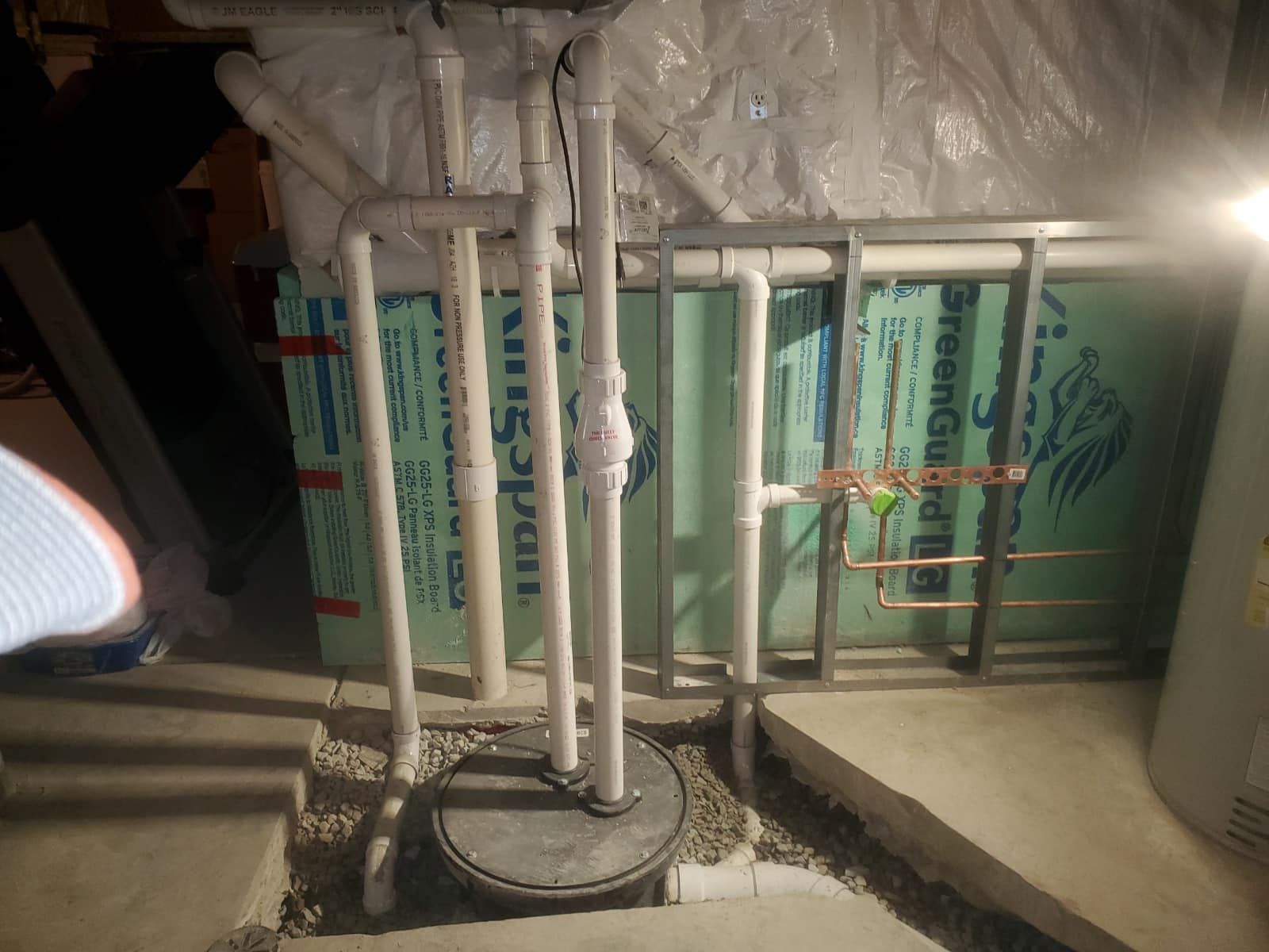 A person is standing in a basement next to a box that says ' trexsol ' on it