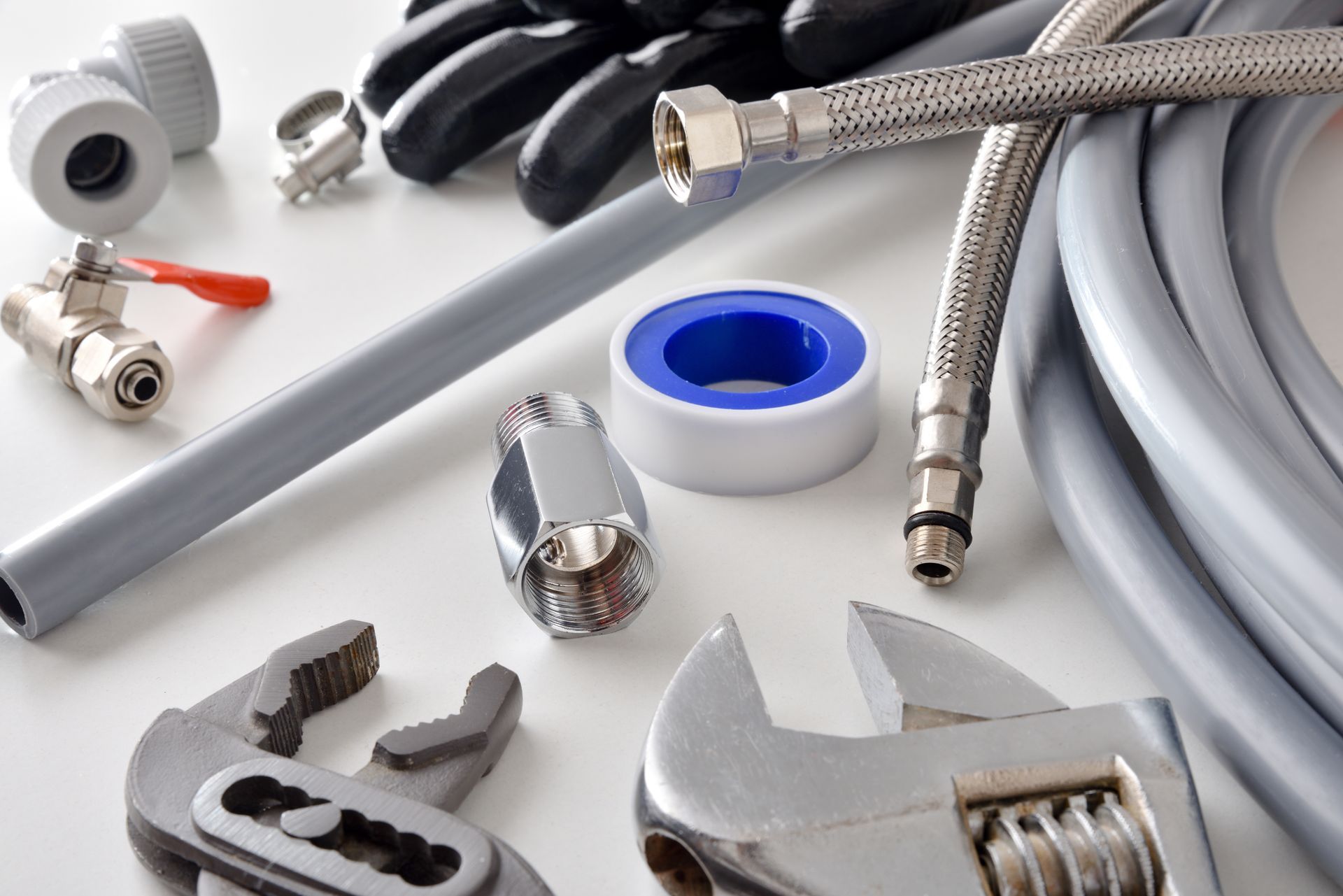 Assorted plumbing supply hardware and tools for home repair and professional installation