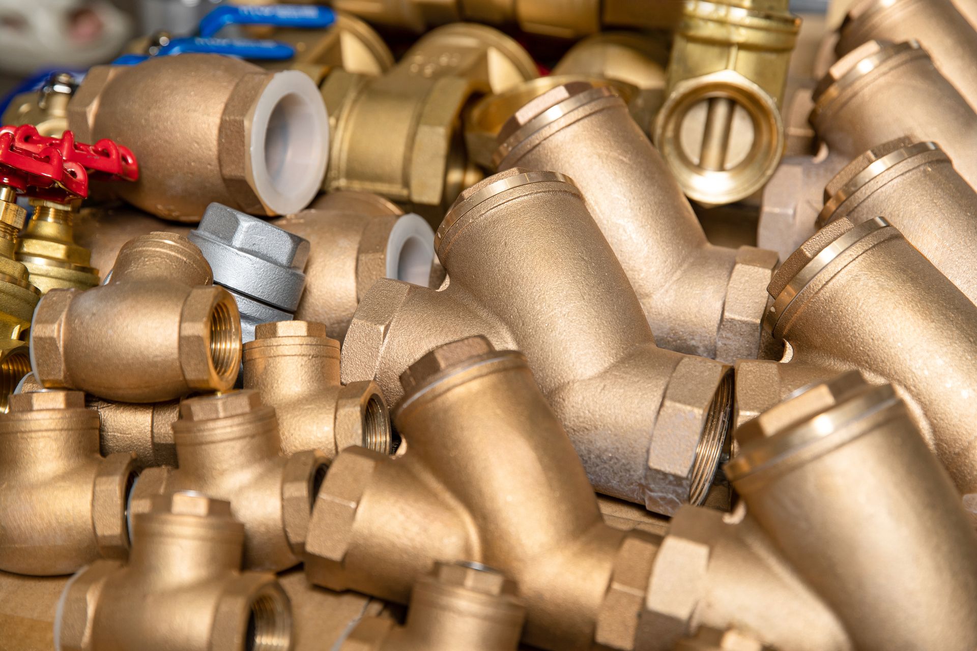 Assorted brass plumbing parts, including valves, connectors, and fittings, on display.