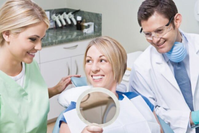 Dentist and patient using mirror - Dentist in Schererville, IN