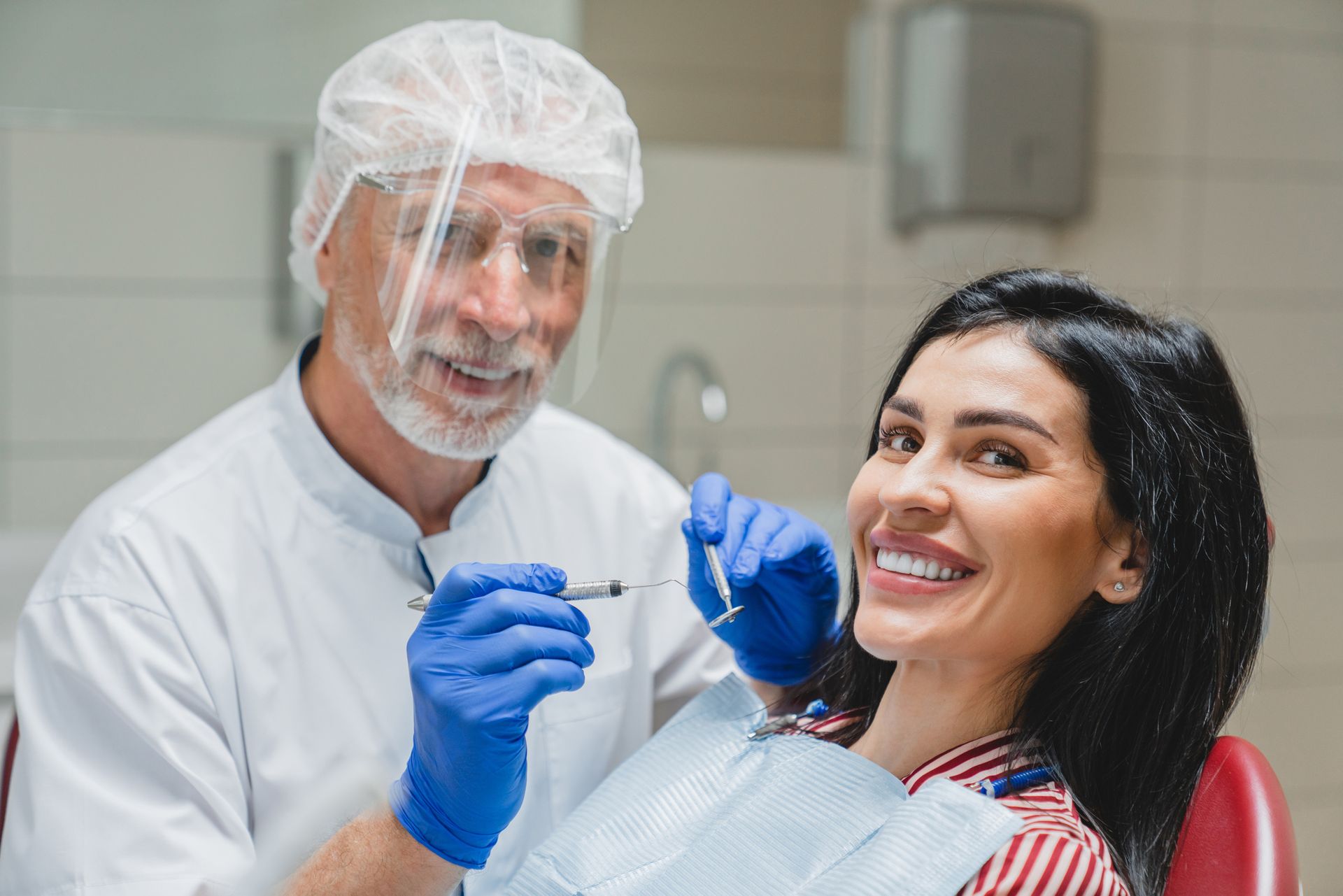 Patient visiting her dentist for regular checkups to keep porcelain veneers looking great.