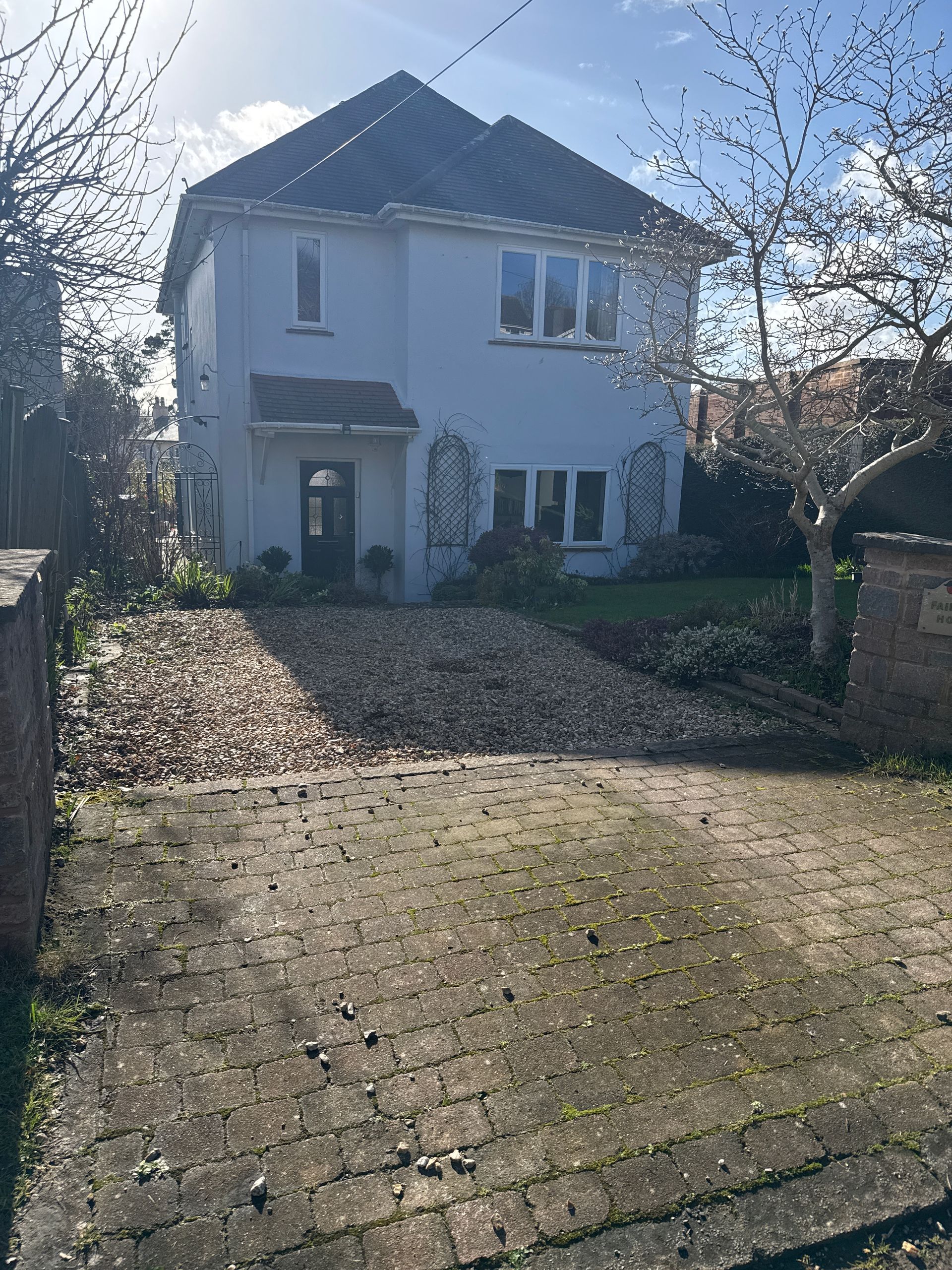 A house with a lot of gravel in front of it.