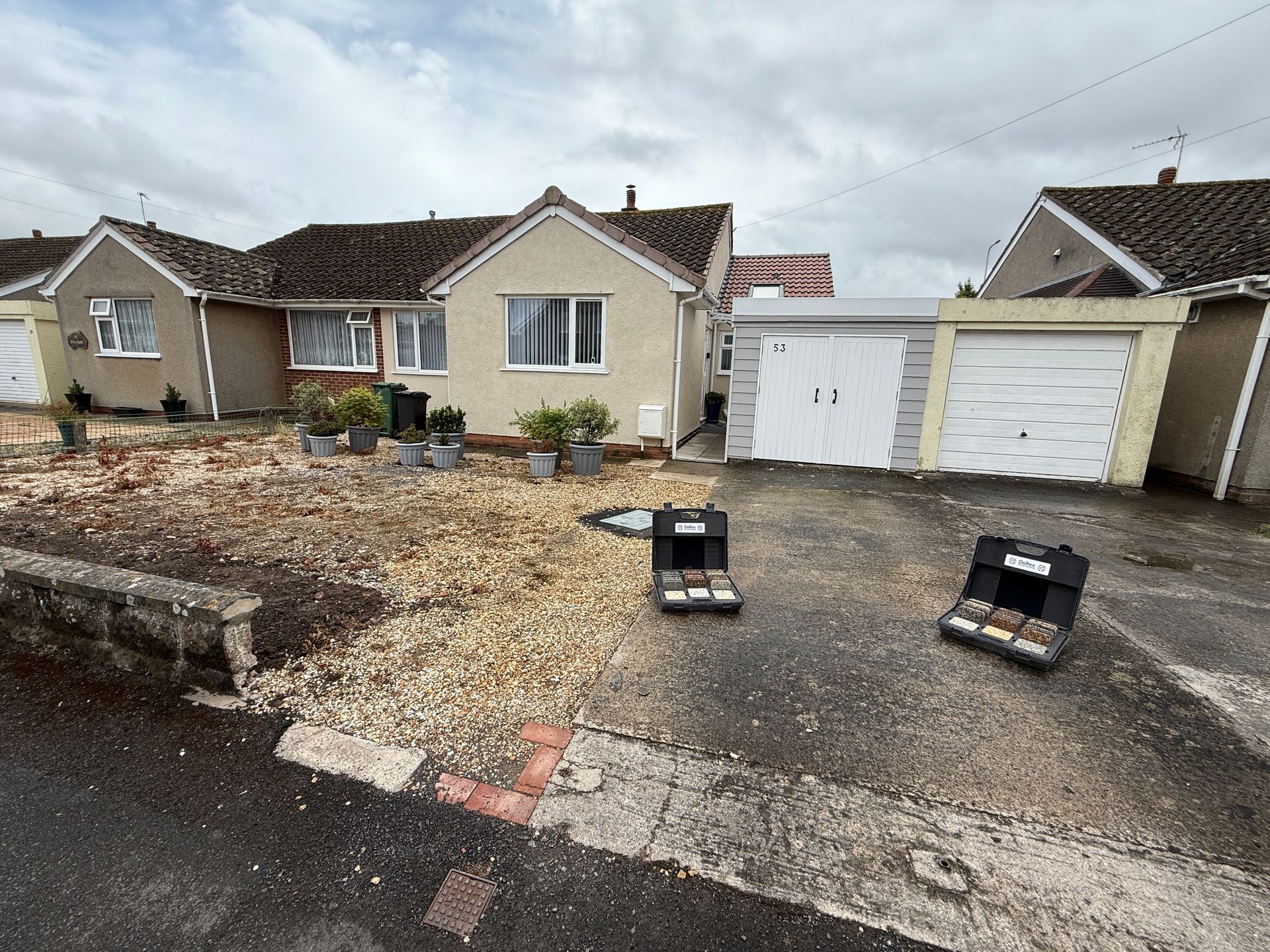 A house with a lot of gravel in front of it.