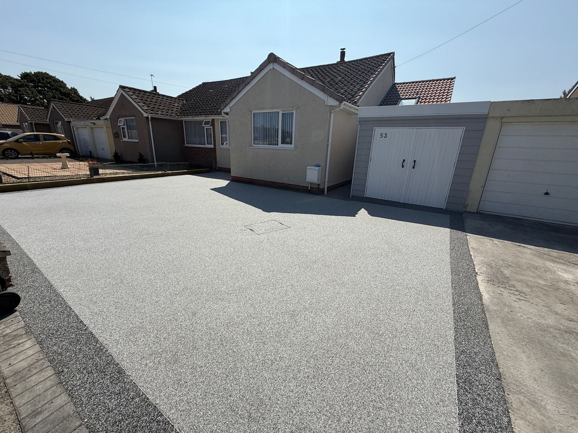 A house with a garage and a driveway in front of it