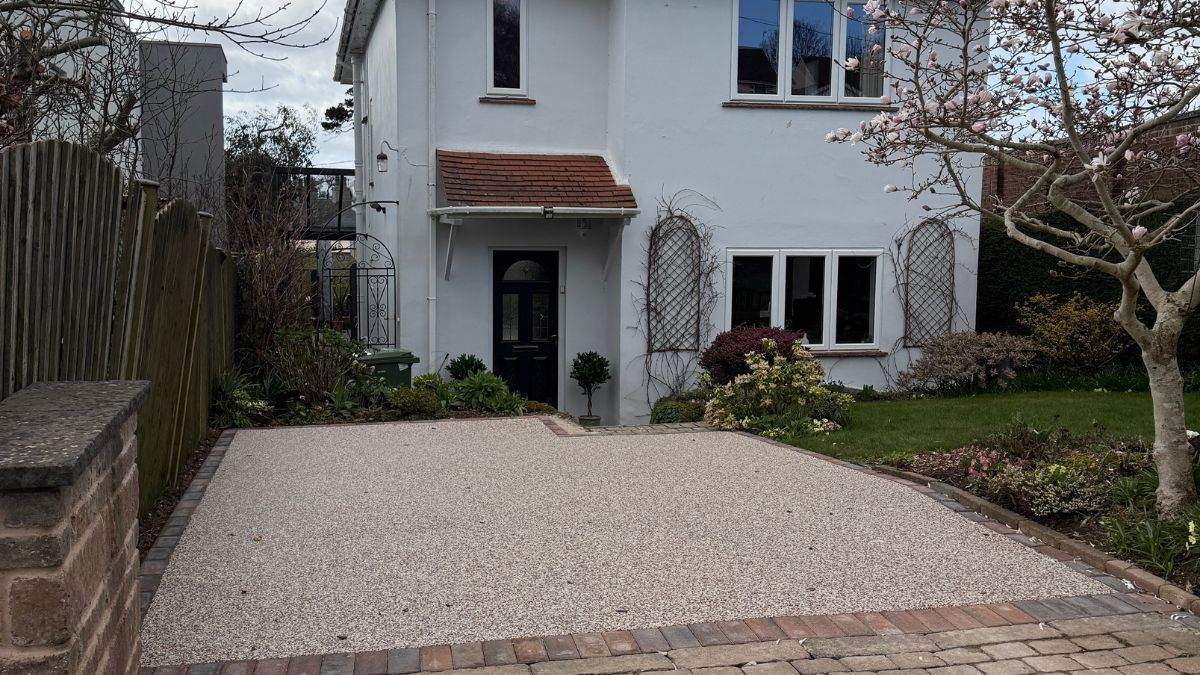 A house with a garage and a driveway in front of it