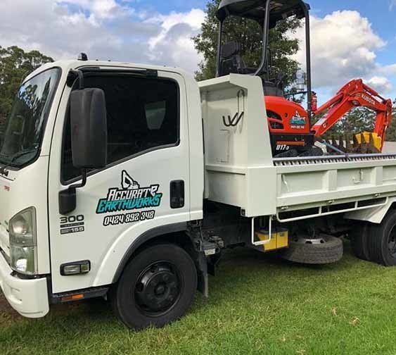 White Truck with Red Excavator — Accurate Earthworks from Gallery in Wollongong, QLD