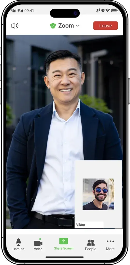 Portrait of a smiling man in a navy blazer on a video call screen, with call controls visible below