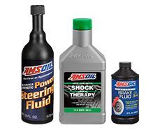 Three bottles of AMSOIL fluids: power steering, shock therapy, and brake fluid.
