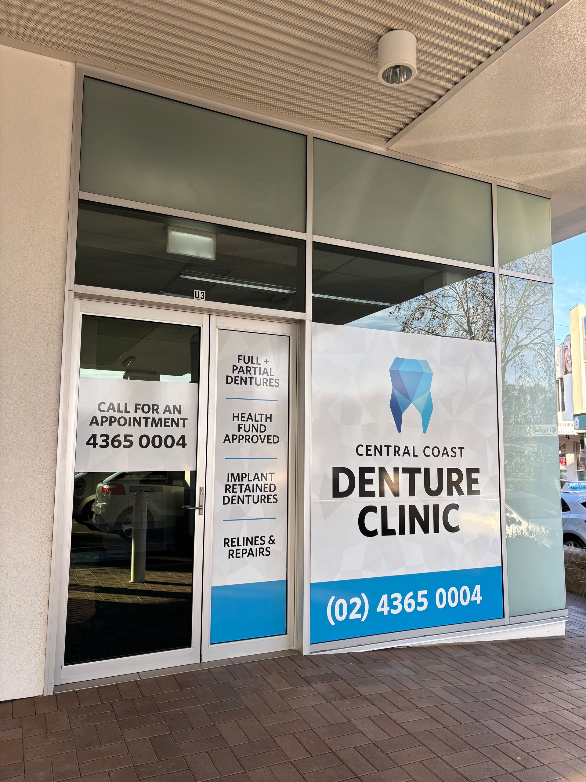 Central Coast Denture Clinic storefront with blue and white signage. Phone number: (02) 4365 0004. — Central Coast Denture Clinic Erina In Erina, NSW