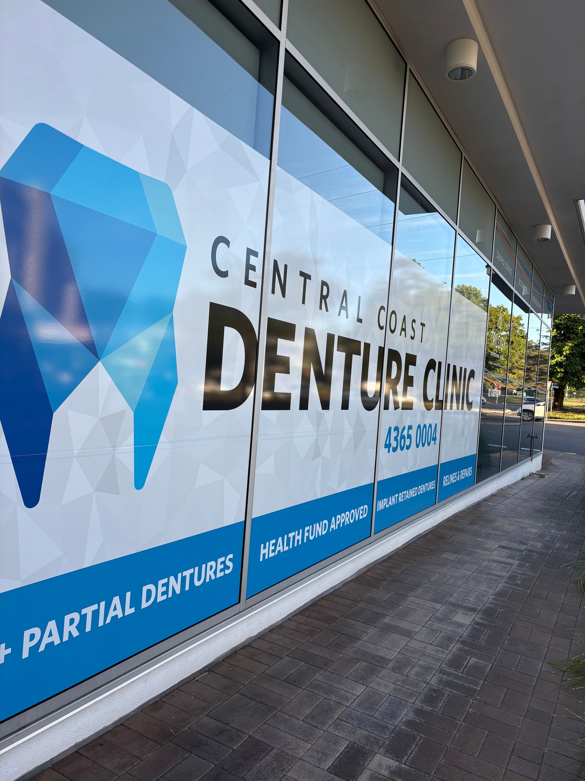 A Dentist and a Patient Are Looking at a Tablet — Central Coast Denture Clinic Erina In Erina, NSW
