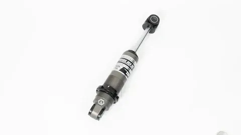 A close up of a shock absorber on a white background.