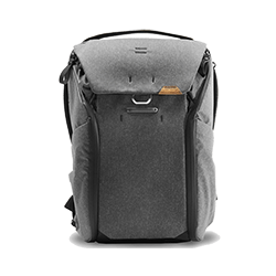 Gray backpack with flap closure and side pockets.