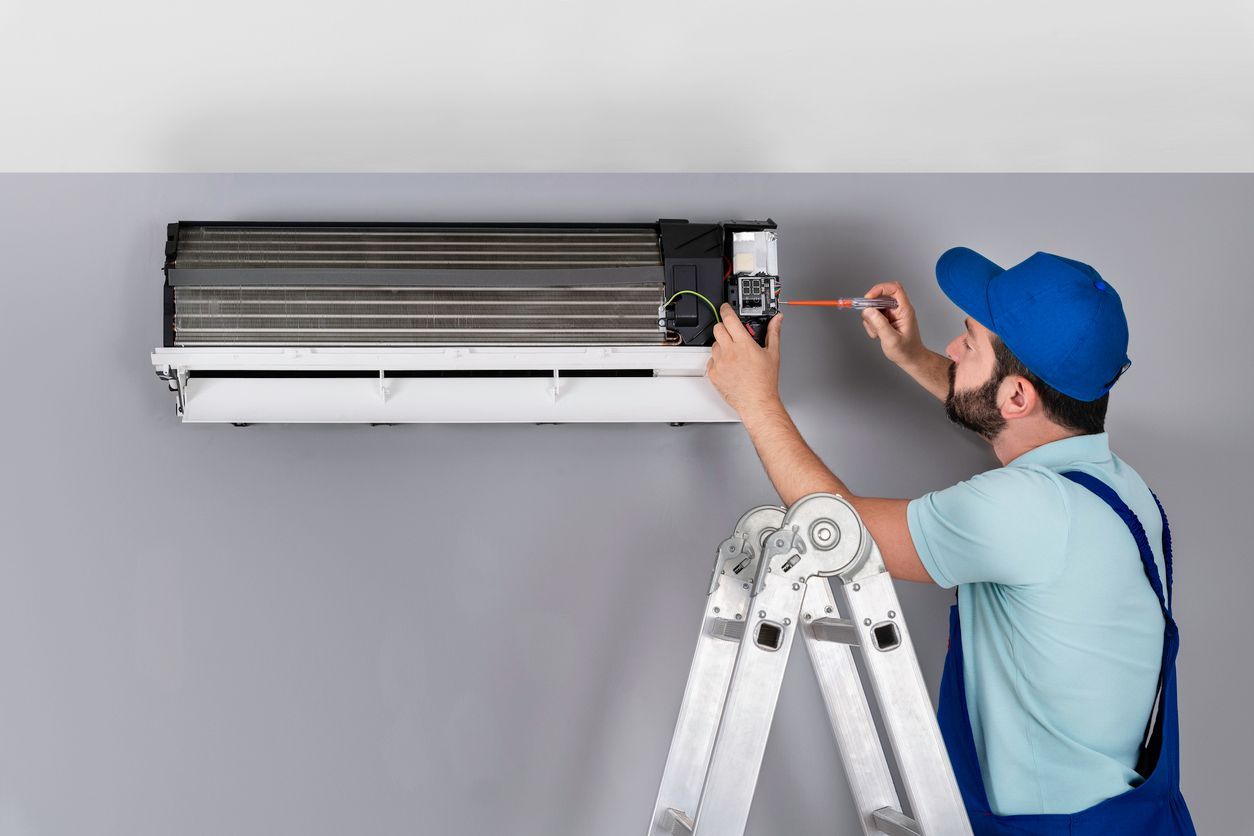 HVAC technician performing routine AC maintenance for membership plan in Fort Lauderdale Florida.