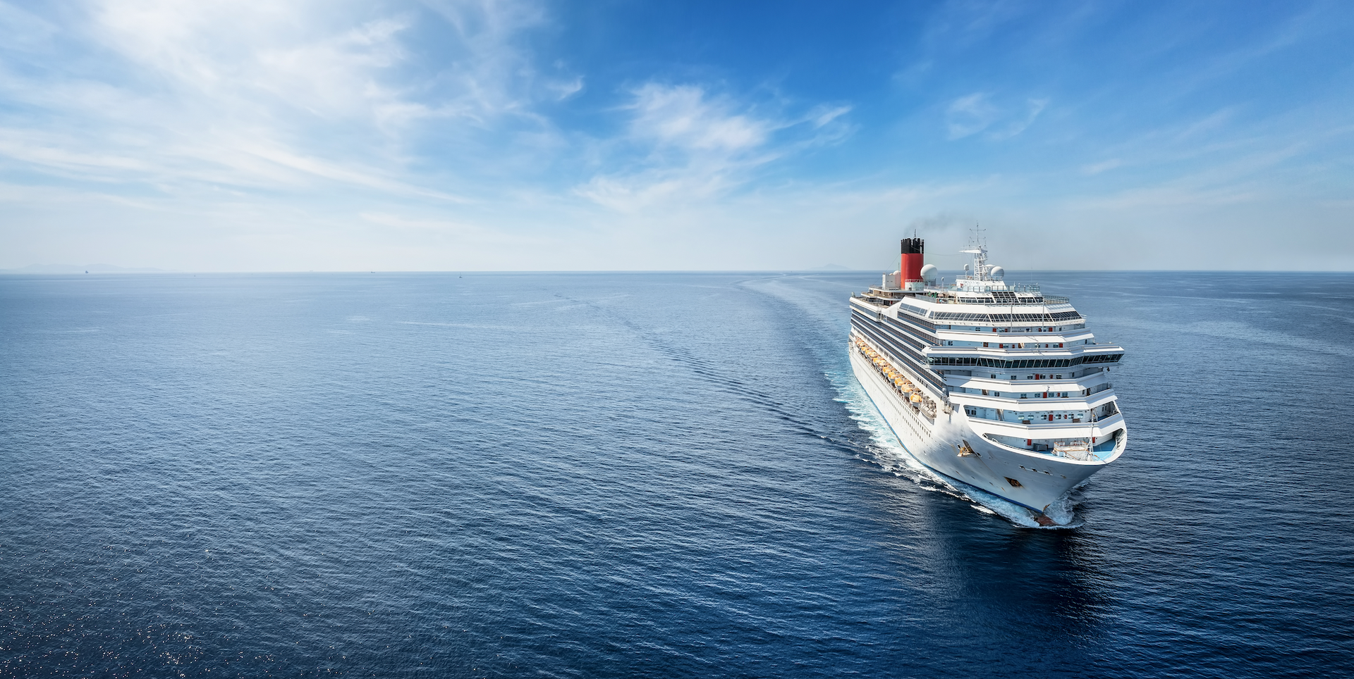 A cruise ship is floating on top of a large body of water.