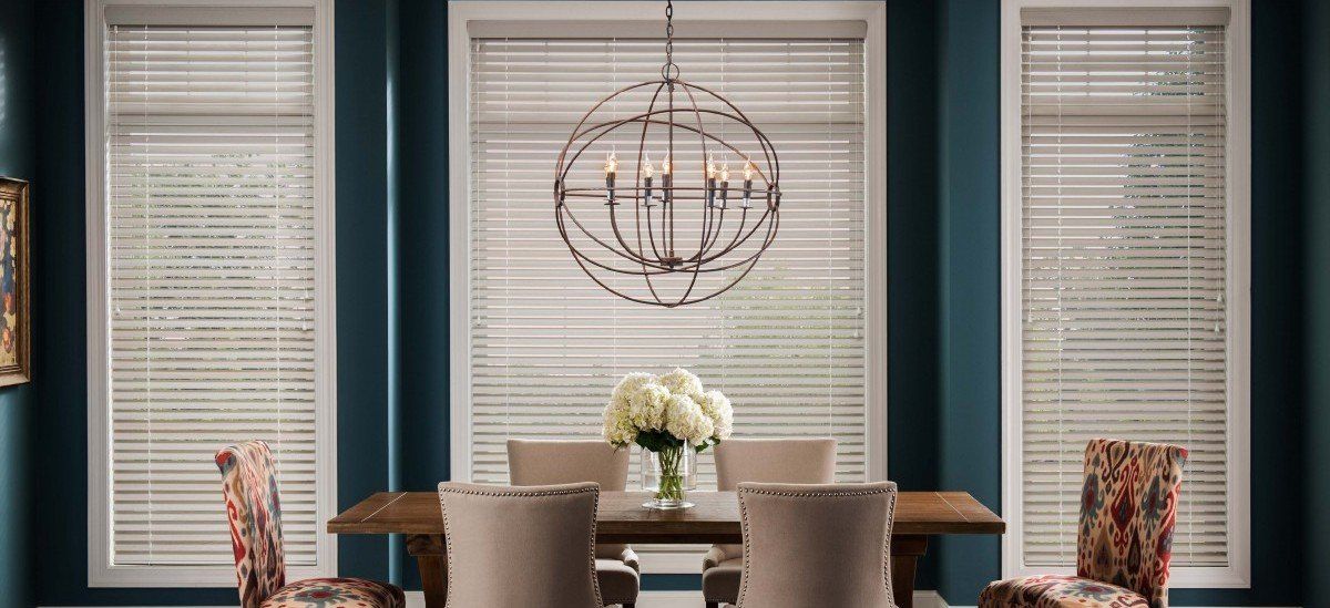 White Wood Blinds in dining area with flowers centerpiece on rectangular brown table