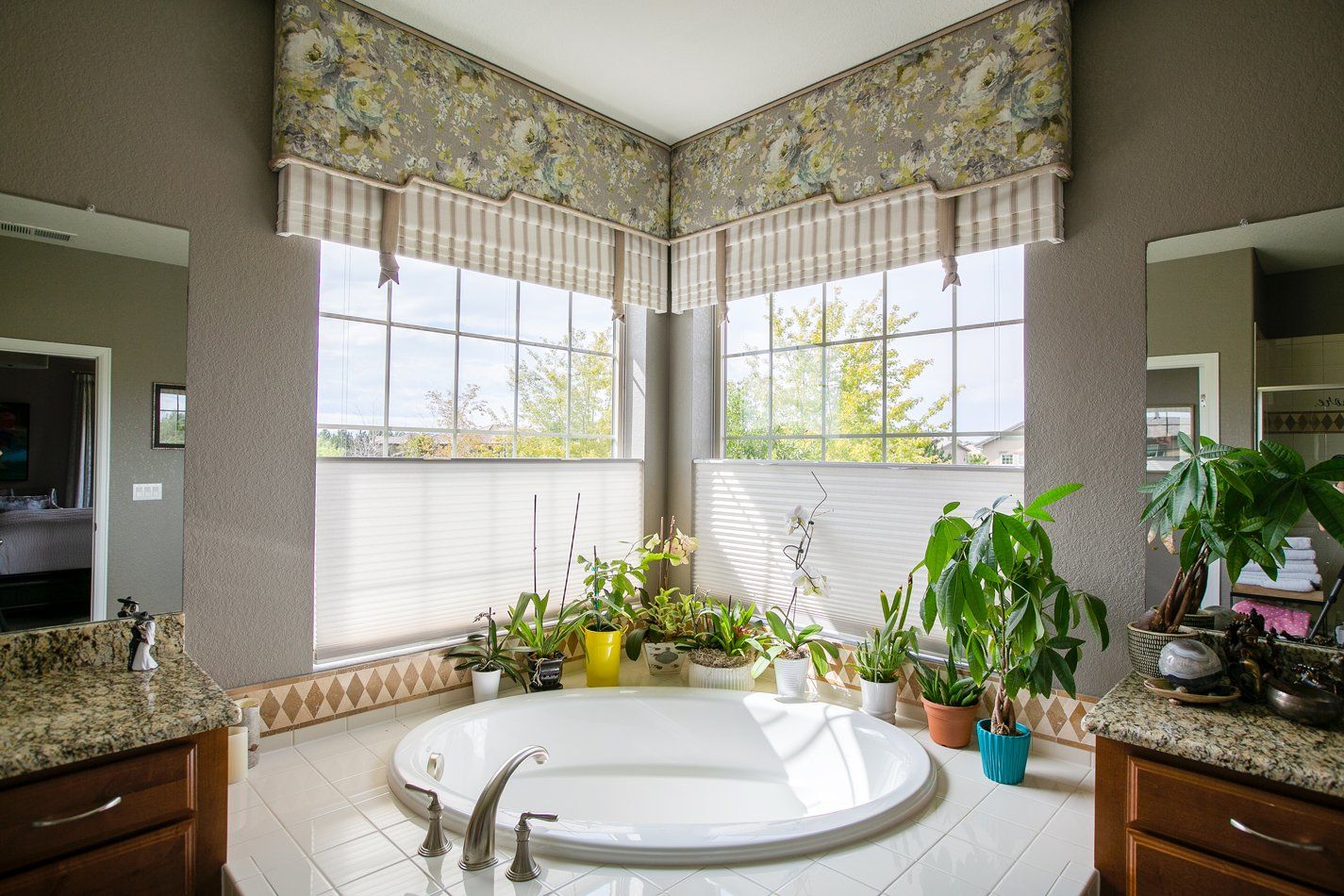 A bathroom with a jacuzzi tub and two sinks.