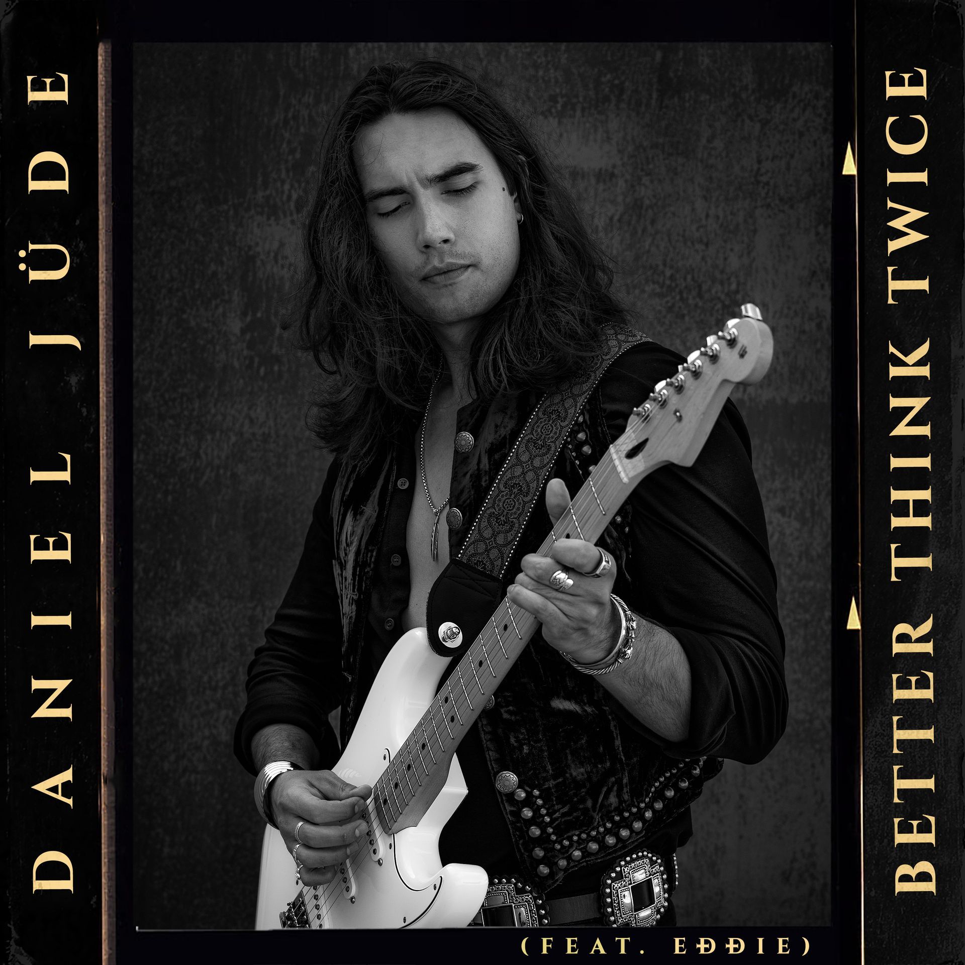 A black and white photo of a man playing a guitar