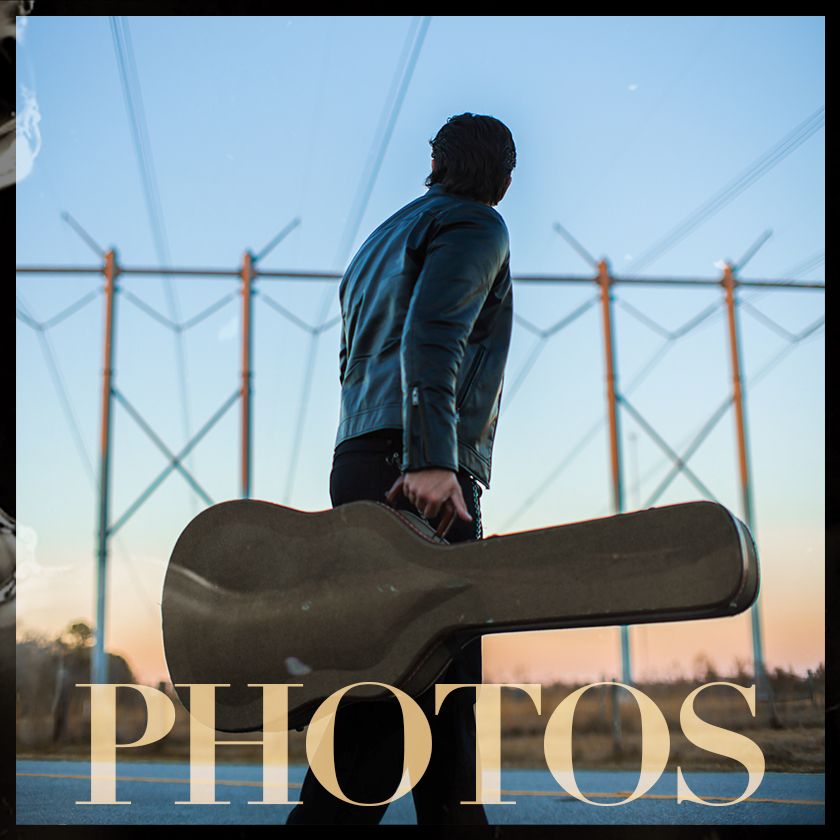 A photo of a man holding a guitar with the words photos above him