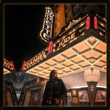 A woman is standing in front of the daniel and jude theater